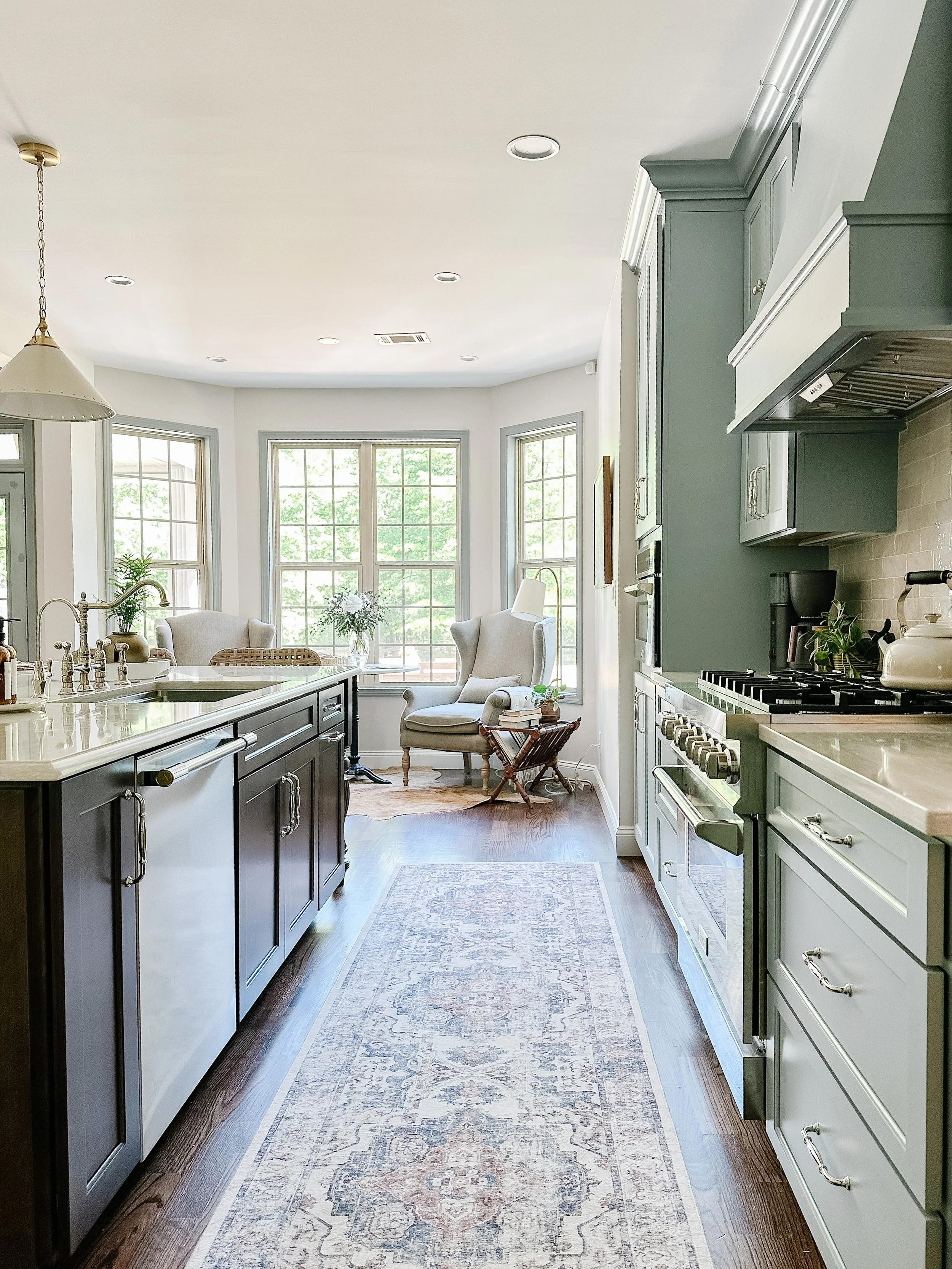 Light blue kitchen with white quartz countertops, walnut island, brass accents, polished nickel hardware, and vintage runner--Casa Limones interior design