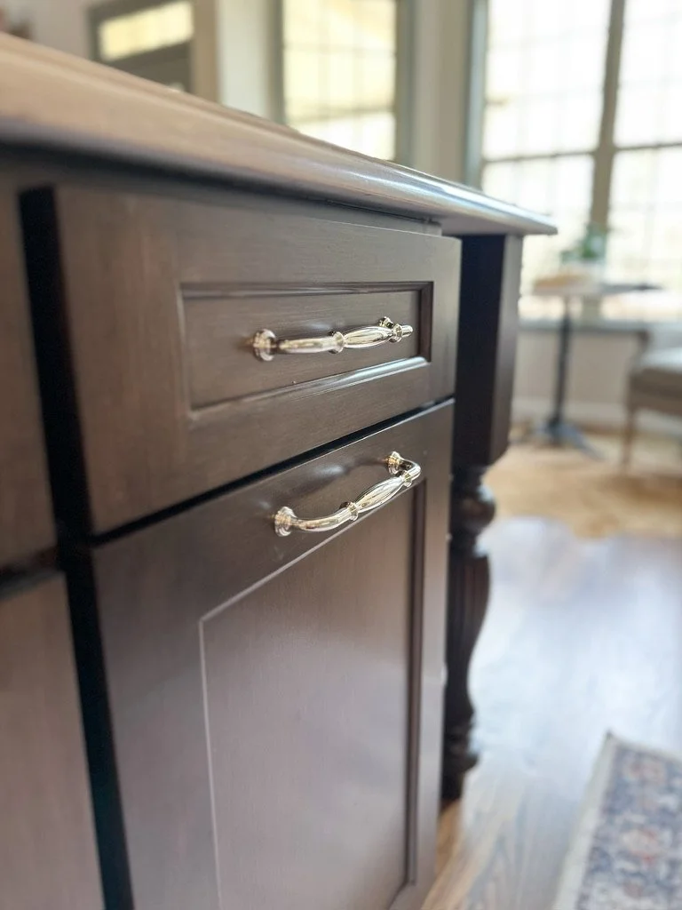 Walnut kitchen cabinets with polished nickel and white dupont edge coutnertops