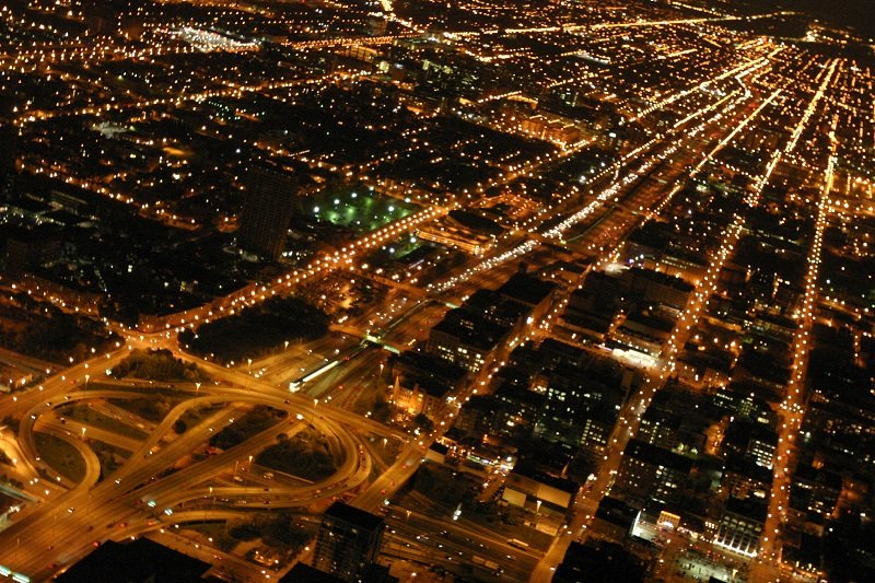 Nighttime aerial view of the windy city with illuminated streets and highways, Photography by Jeremy Norton