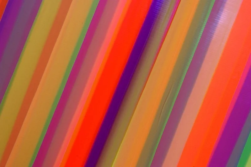 Close-up of colorful striped straws arranged parallel to each other.