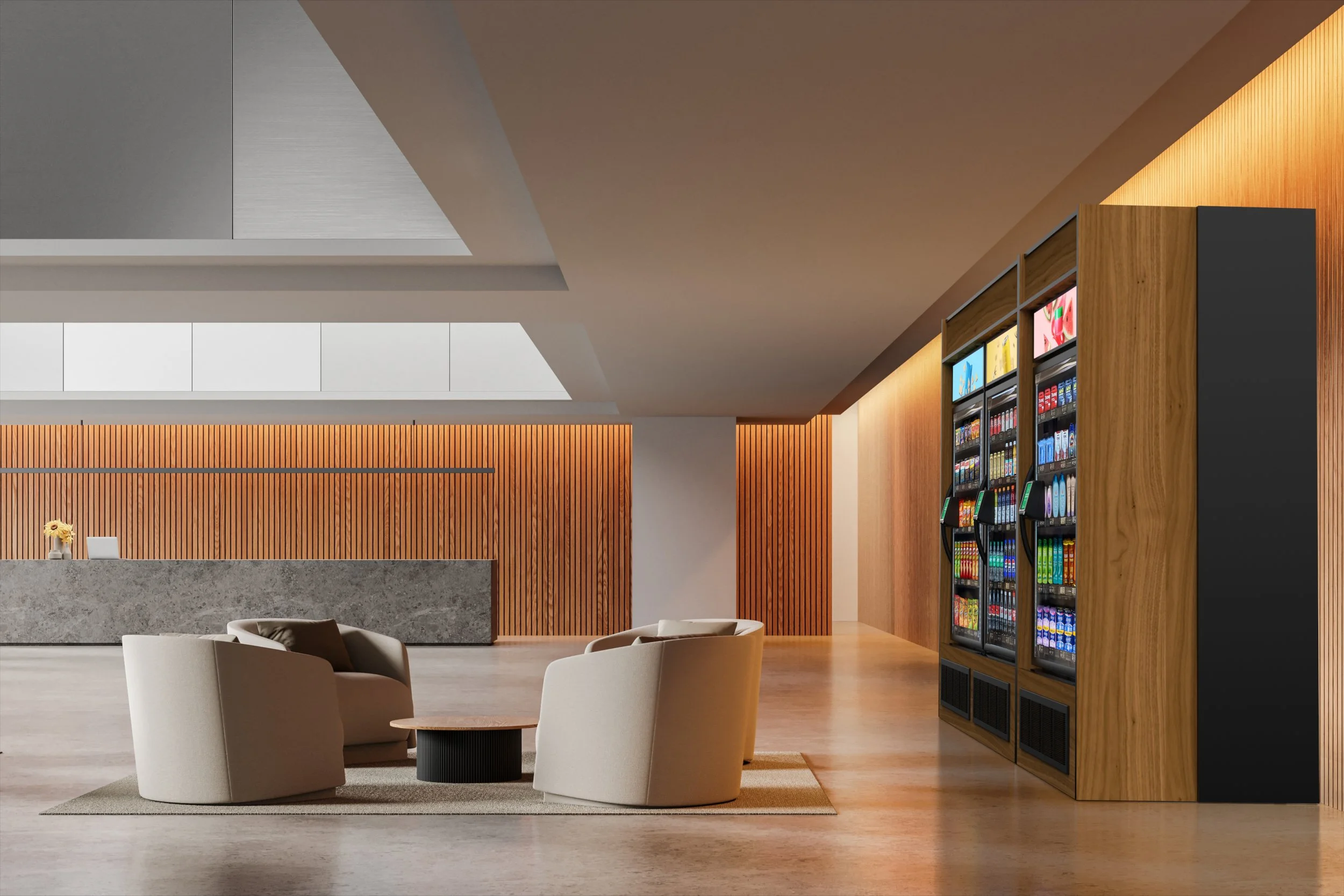 Lobby with wooden wall panels, a granite reception desk, a seating area with beige chairs around a small round table, and vending machines against a wooden wall.