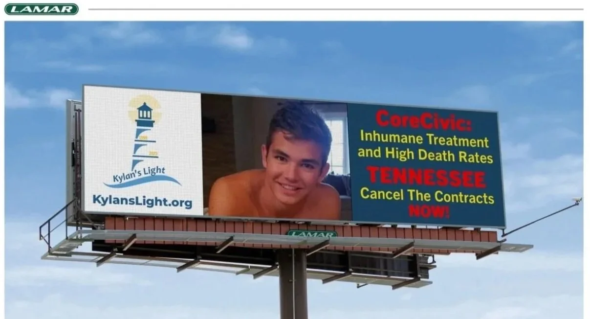 Billboard with an image of a smiling young man and text promoting KylansLight.org and criticizing CoreCivic, Tennessee, for inhumane treatment and high death rates.