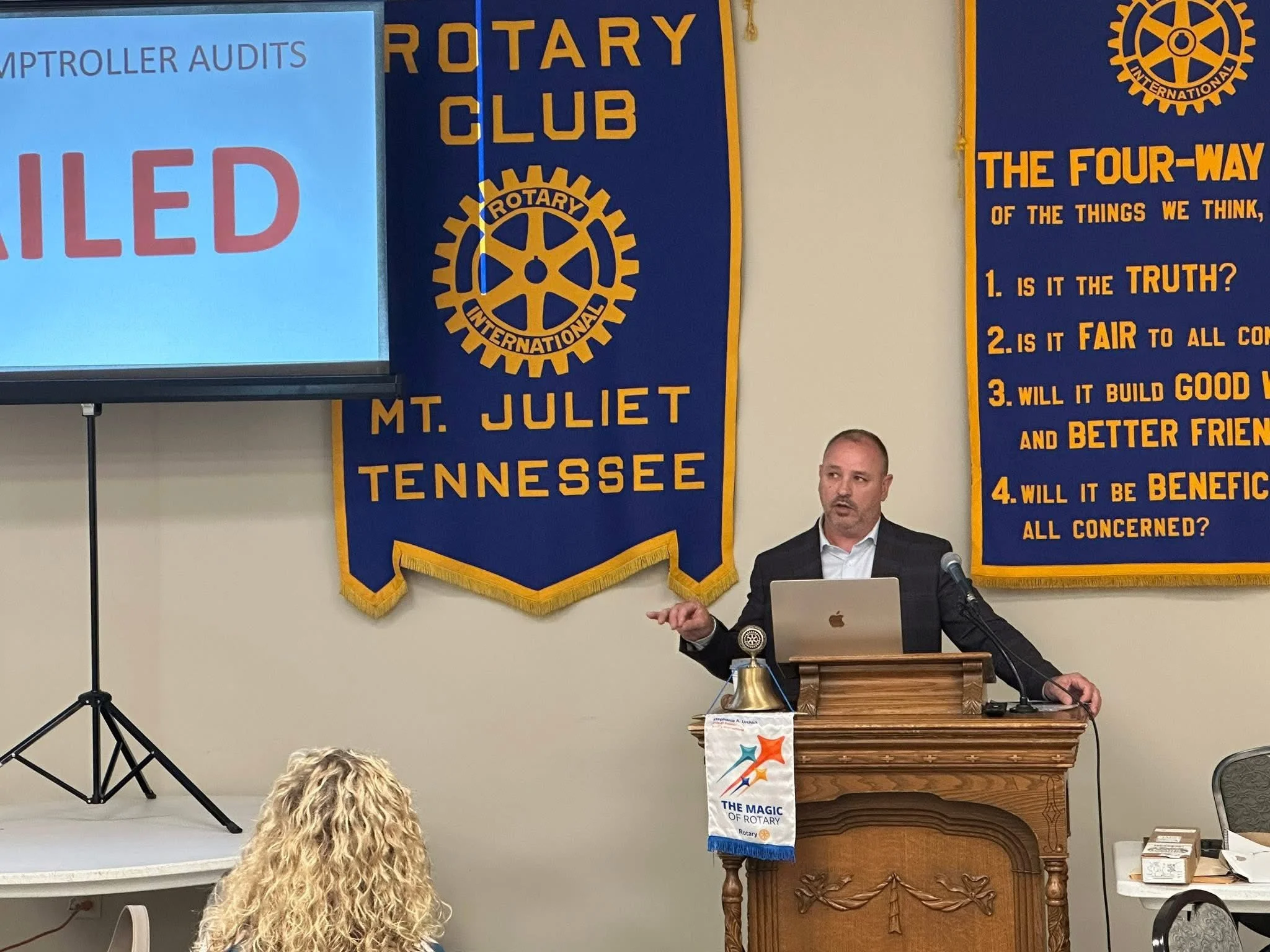 Tim Leeper speaking about prison reform awareness at community leadership event in Tennessee camera, listening to the speaker.