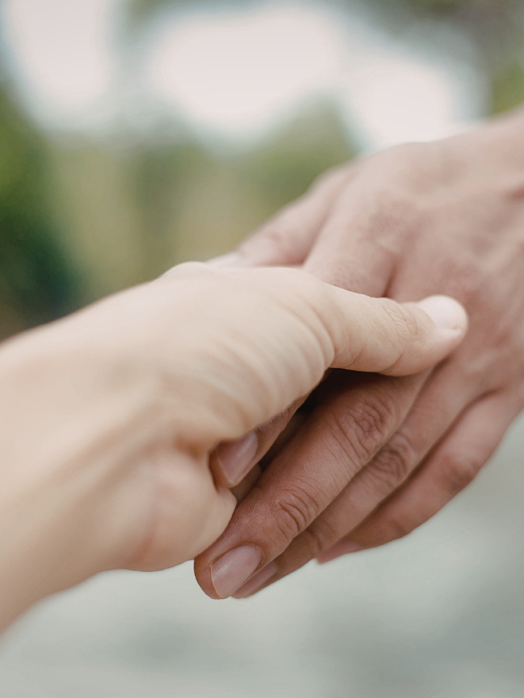 Hands showing compassion and support for families affected by incarceration and reentry challenges