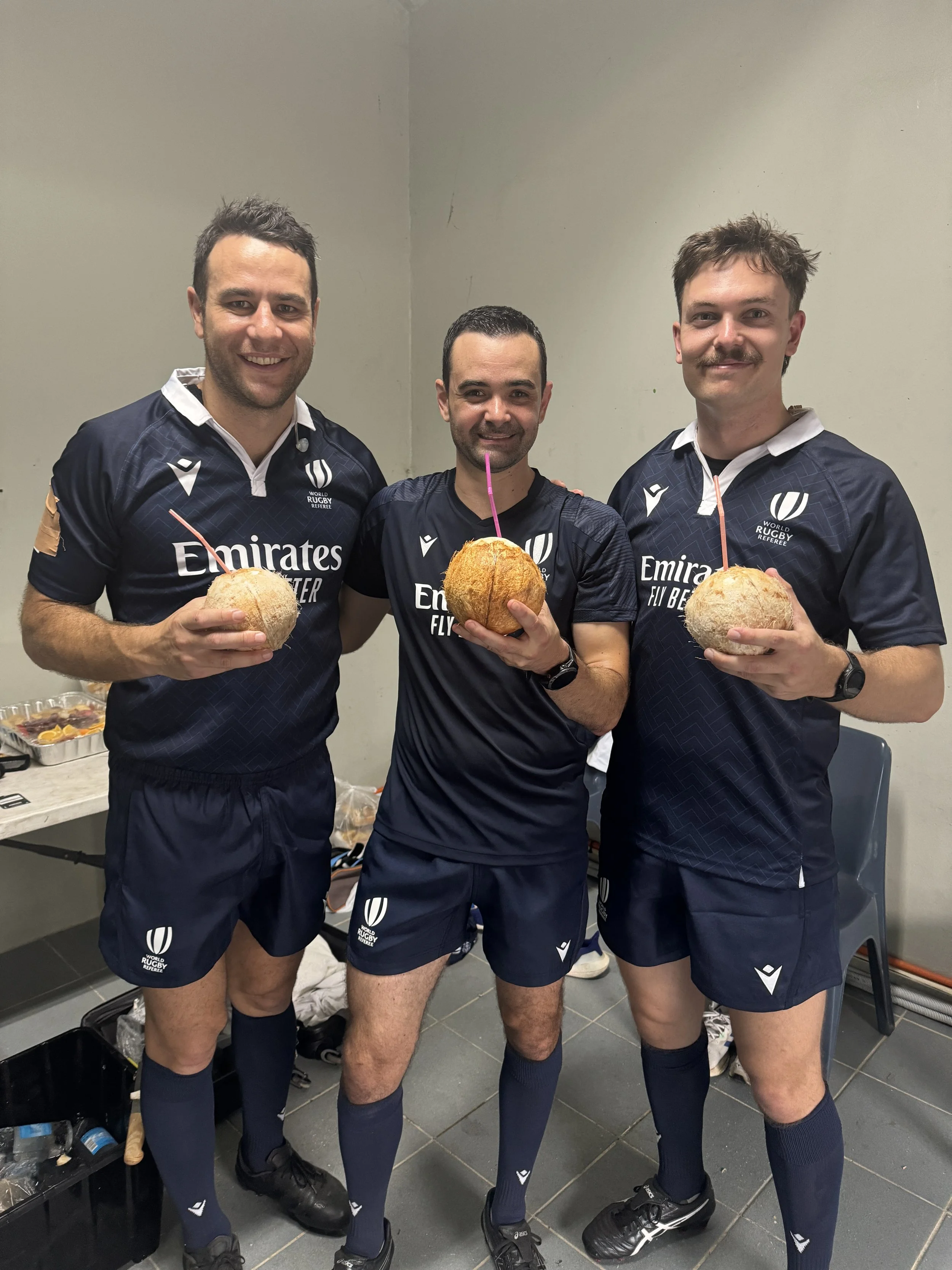 Referee Ben O'Keeffe after refereeing Fiji v Tonga standing with some fresh coconuts