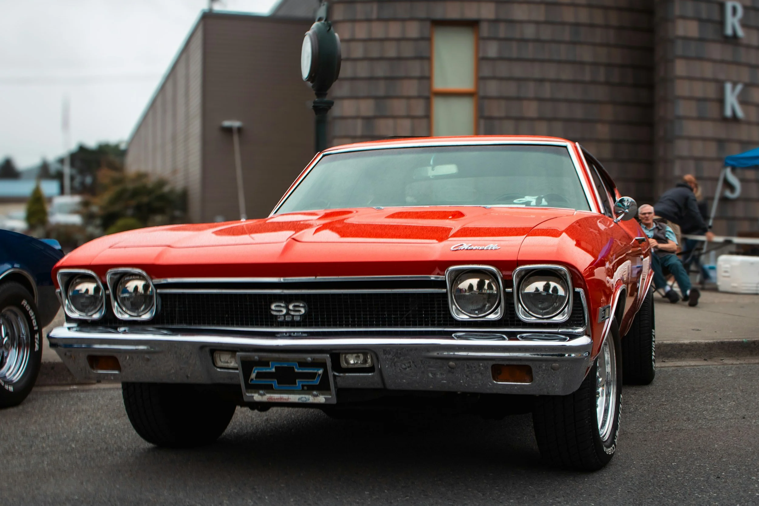 A red vintage Chevrolet Camaro SS car parked on the street.