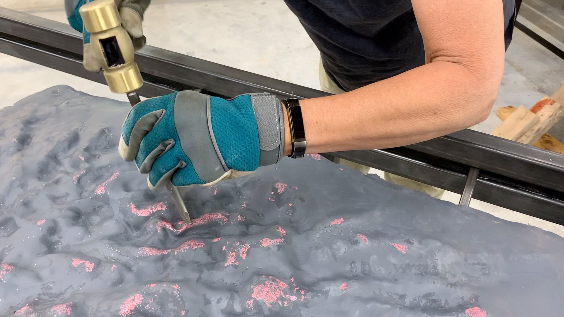 Diana Ahrens hand-hammering annealed copper prior to vitreous enamel furnace melt.