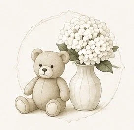 A teddy bear sitting next to a vase of white hydrangea flowers.
