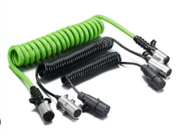Color-coded coiled microphone cables with XLR connectors in black and silver, with a green extension cord.