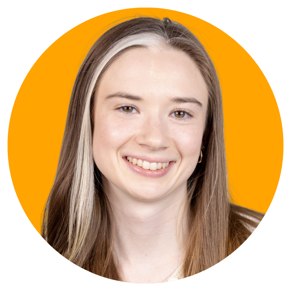 A young woman with long light brown hair and a small hoop earring, smiling in front of a bright orange background.