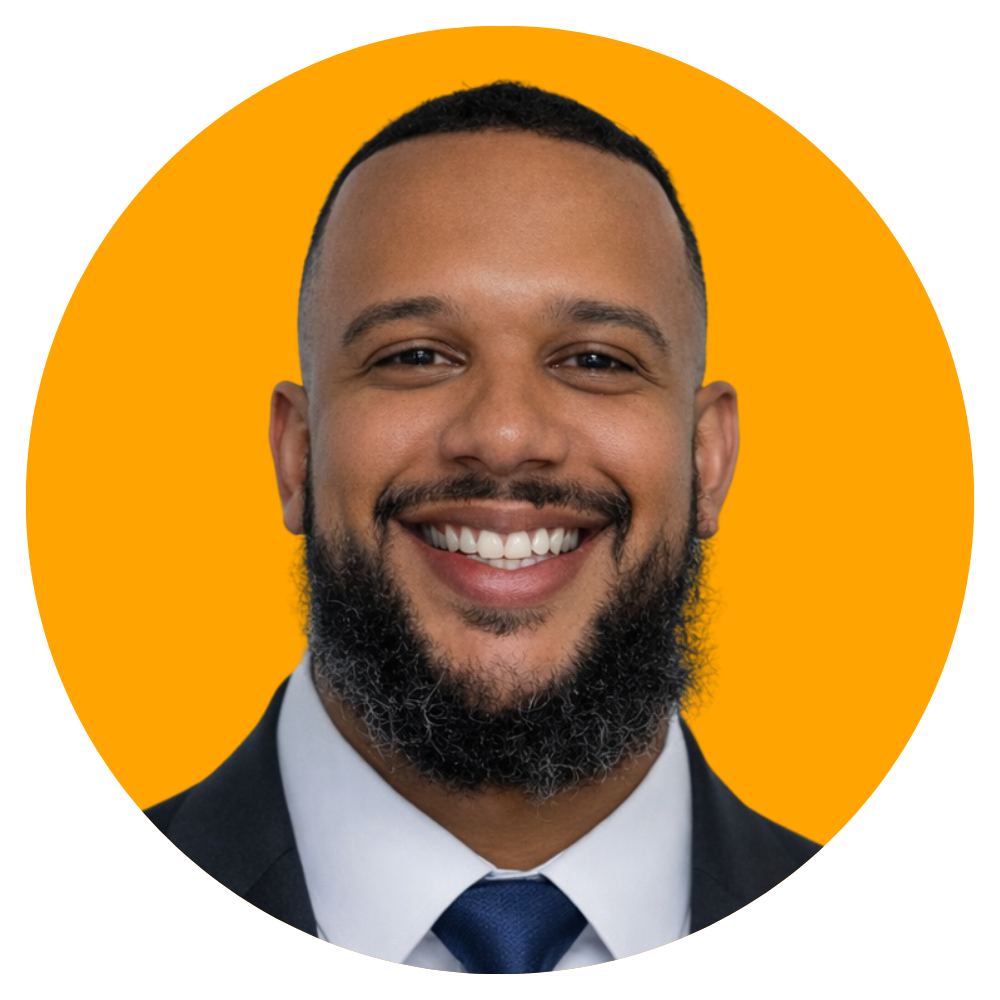 A smiling man with a beard, wearing a suit and tie, against an orange circular background.