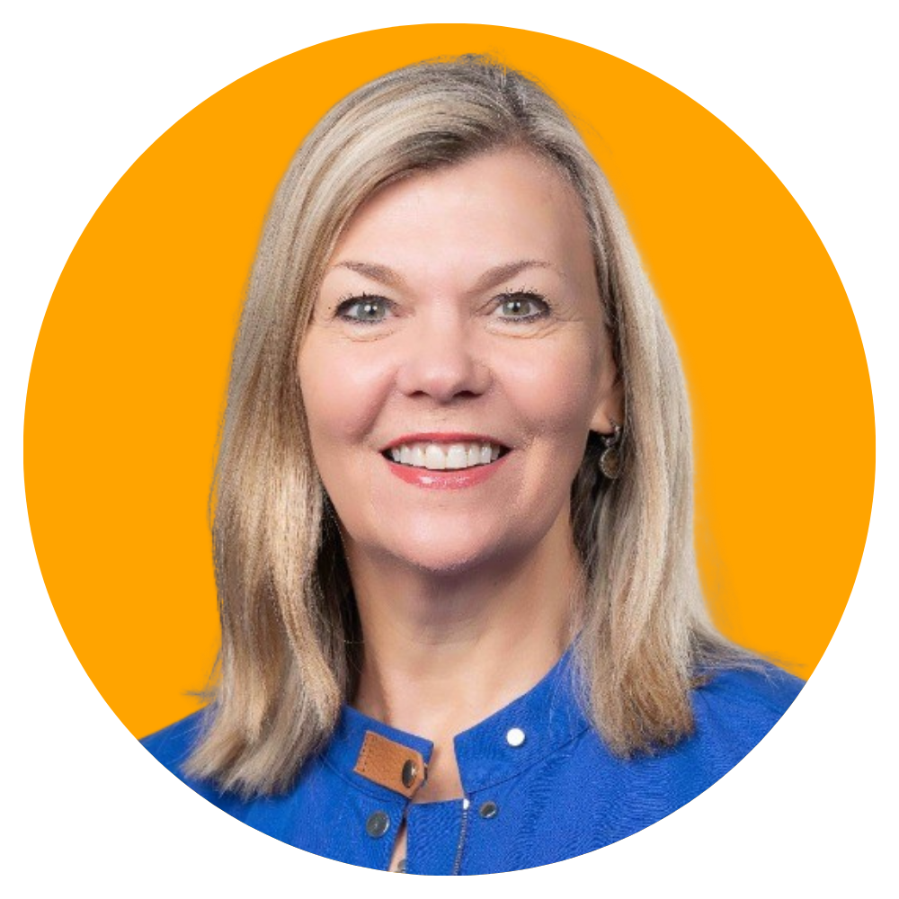 A woman with shoulder-length blonde hair, blue eyes, wearing a blue top, smiling, with an orange background.