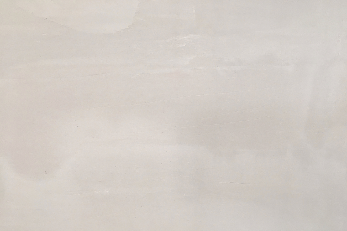 A plain, off-white wall with subtle texture and smooth surface.