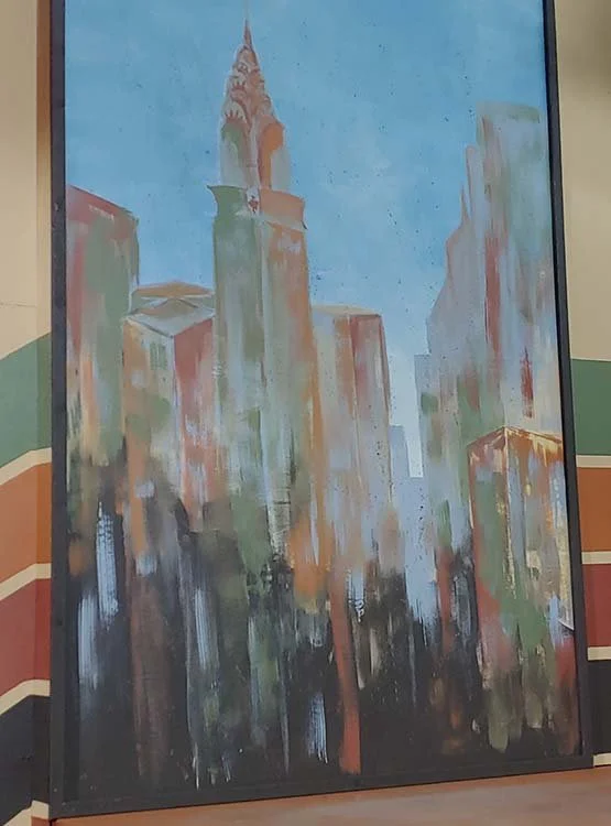 Abstract painting of a city skyline with tall buildings in pastel colors and dark shadows.