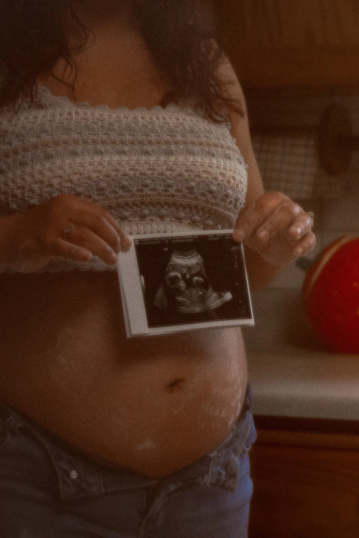 Pregnant woman sharing ultrasound. belly.