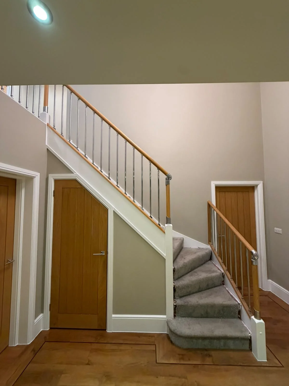  Staircase with white painted woodwork and freshly painted walls after decorating 