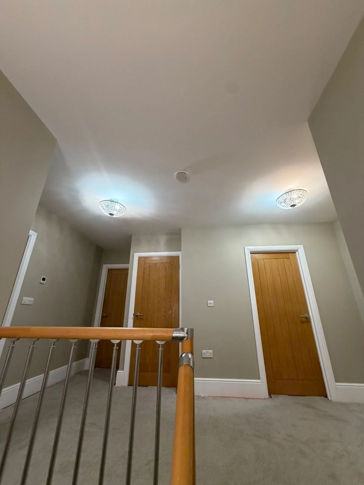  Landing with freshly painted walls, ceiling and white door frames after decorating 