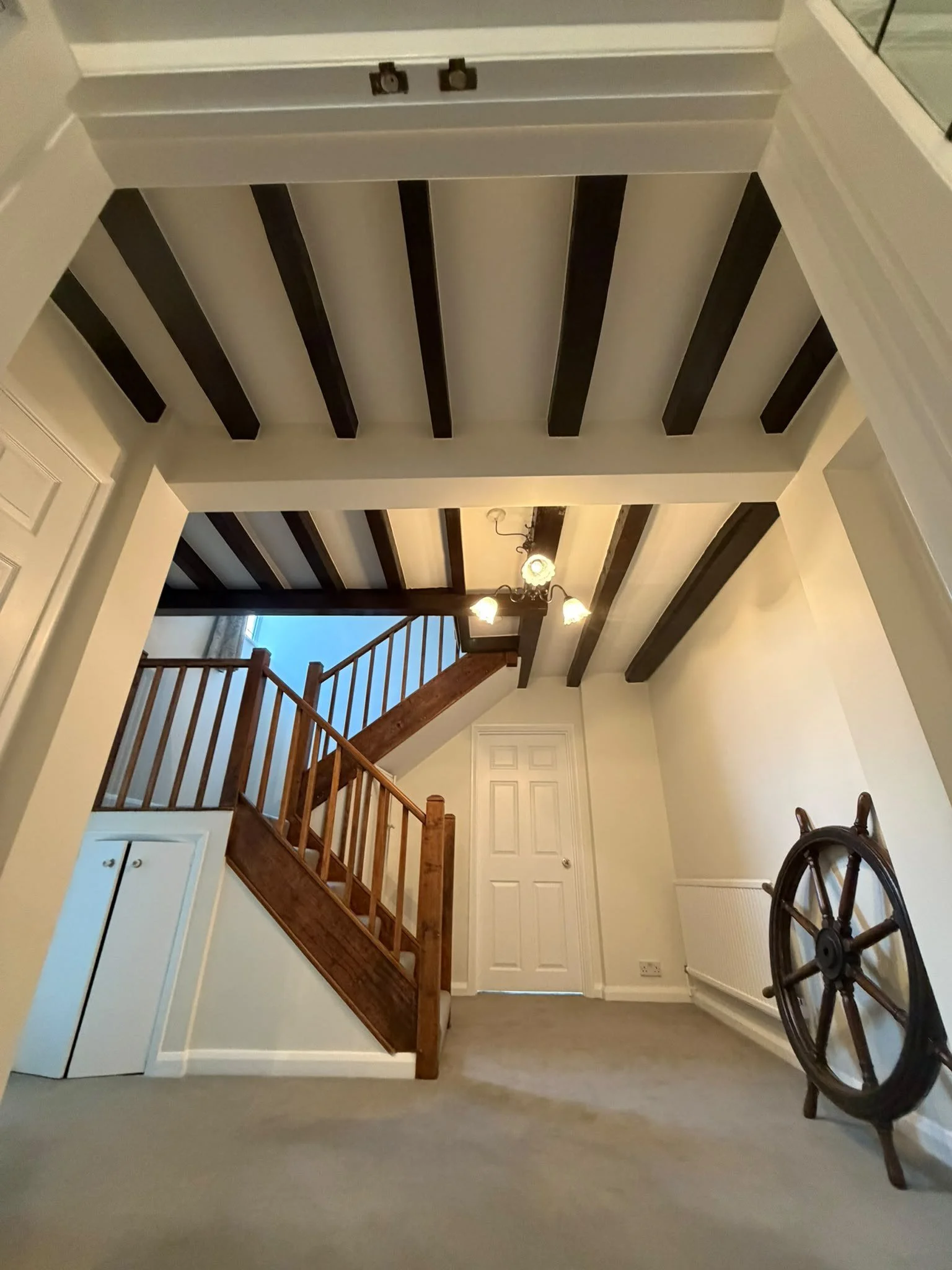 finished-hall-stained-beams-staircase-white-ceiling.jpg