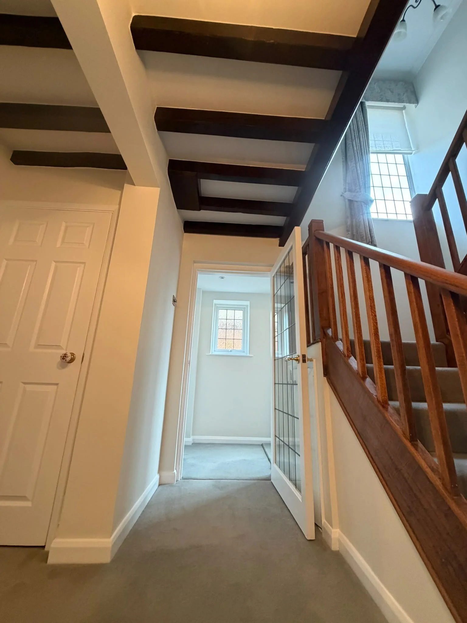 finished-landing-beams-oak-banister-white-woodwork.jpg