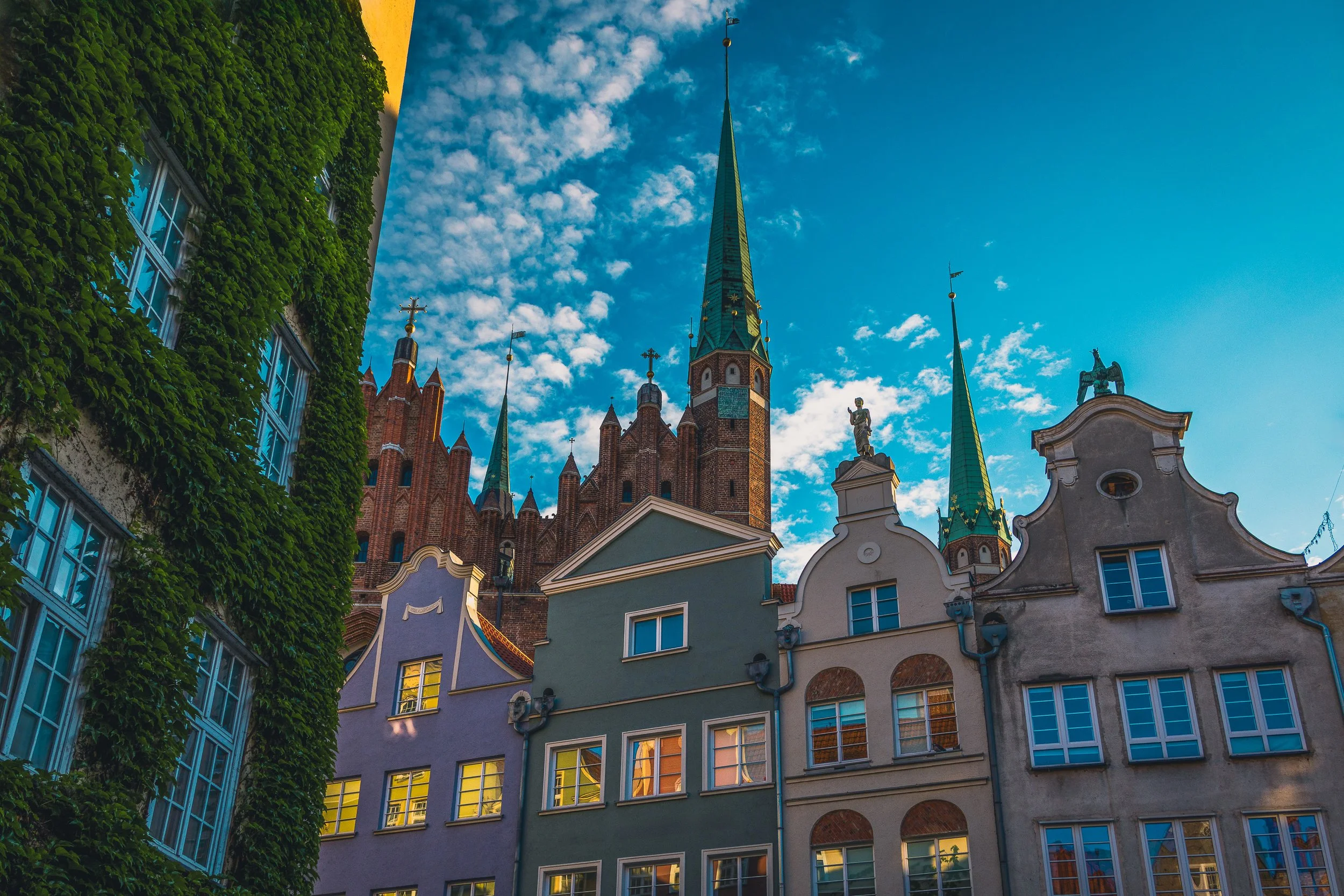 Historic rooflines and towers forming geometric shapes against the sky in Gdańsk