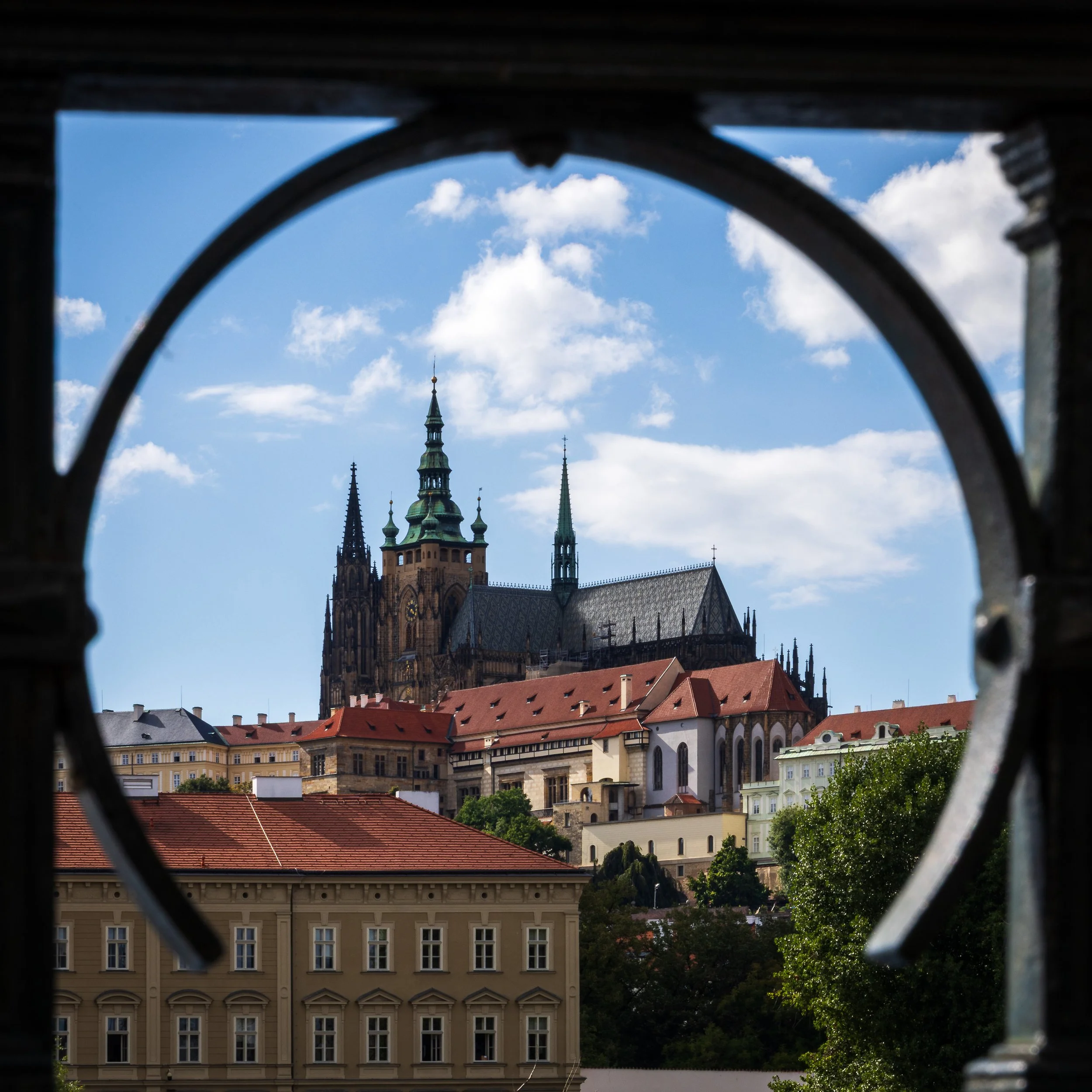 Prague Castle framed through a dark architectural opening