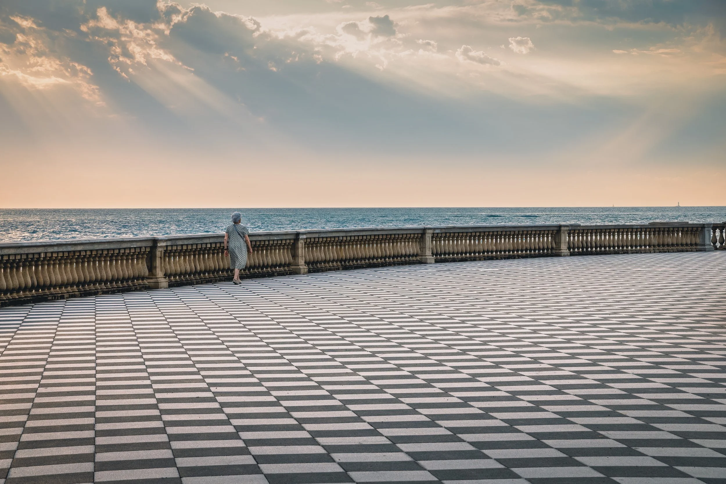 Black and white checkerboard promenade at Terrazza Mascagni in Livorno beside the sea