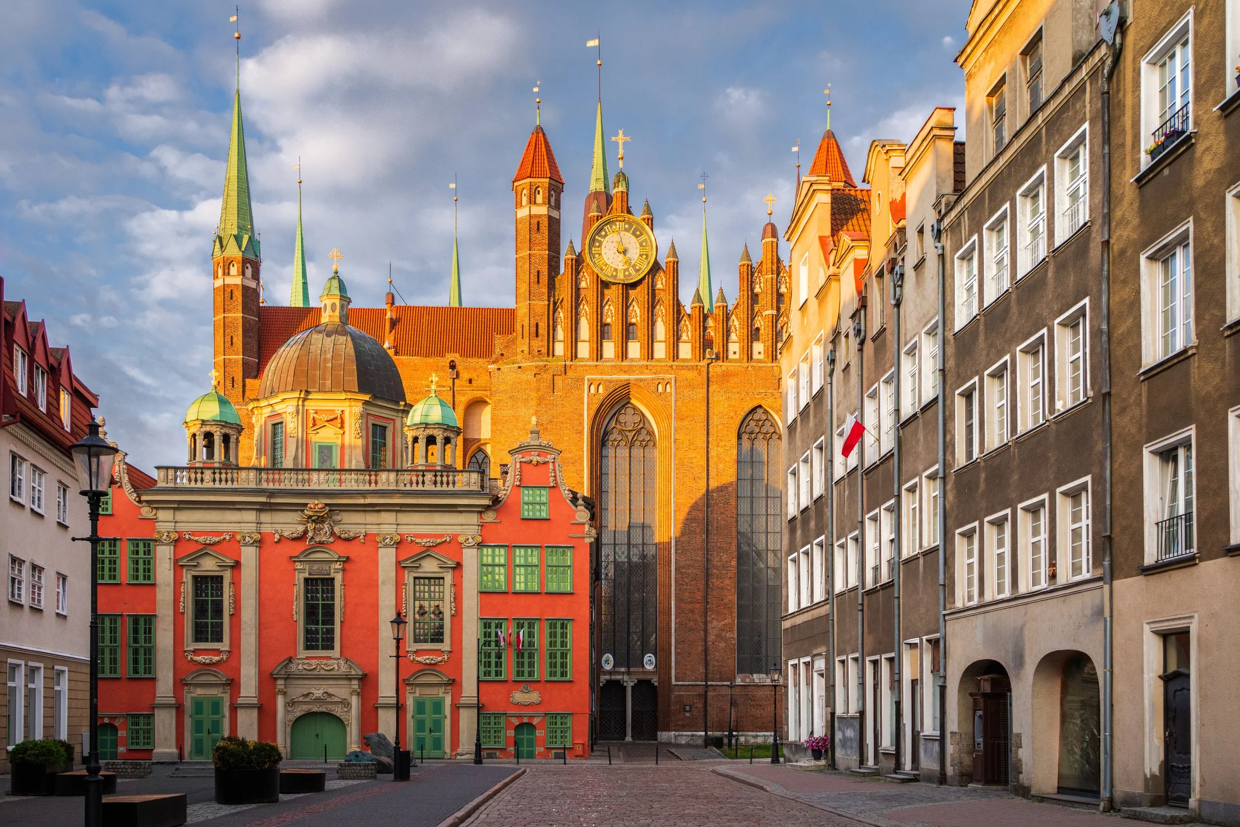 Historic townhouses in Gdańsk lining a quiet street in the early morning.