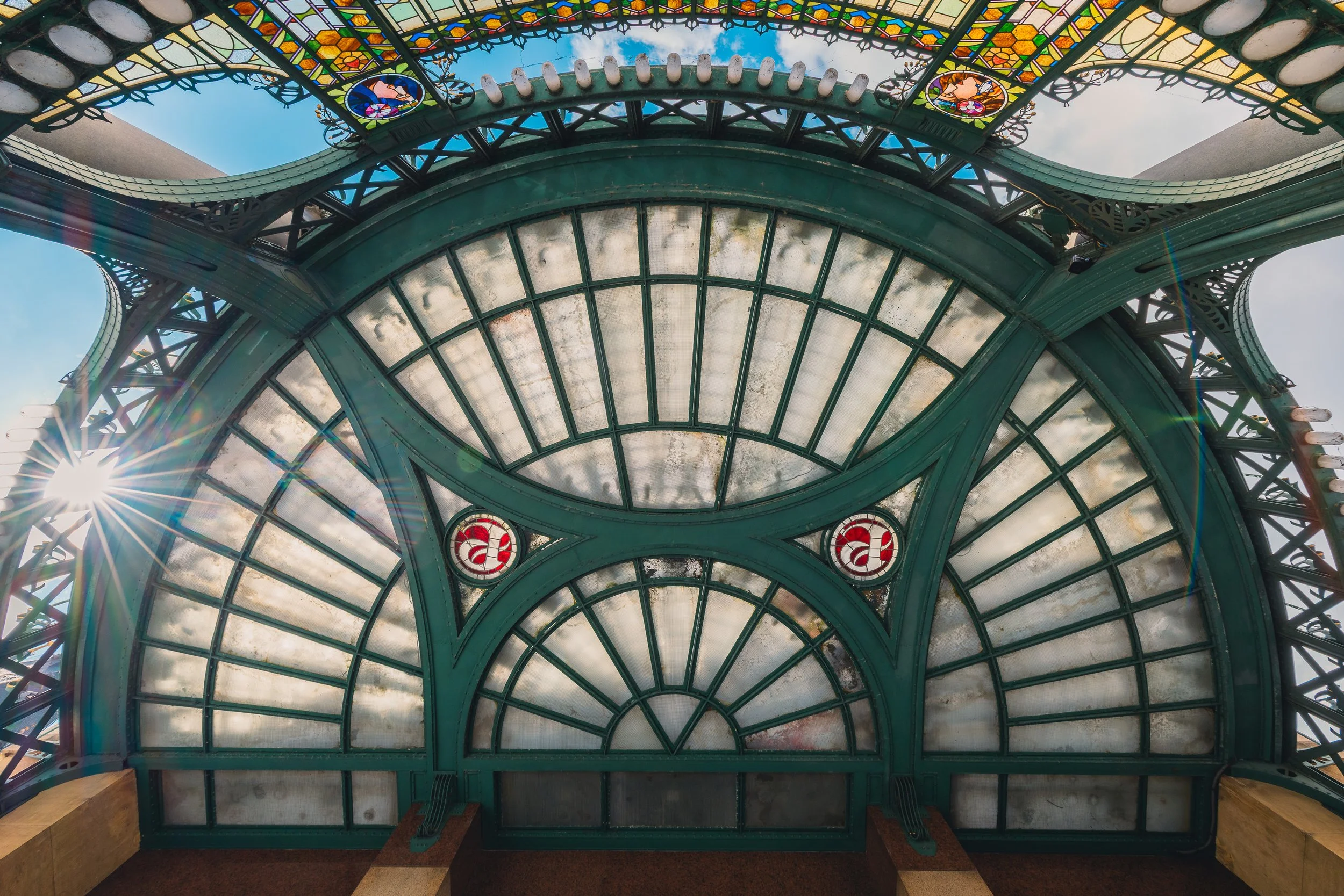 Geometric stained-glass dome viewed directly from below in Prague