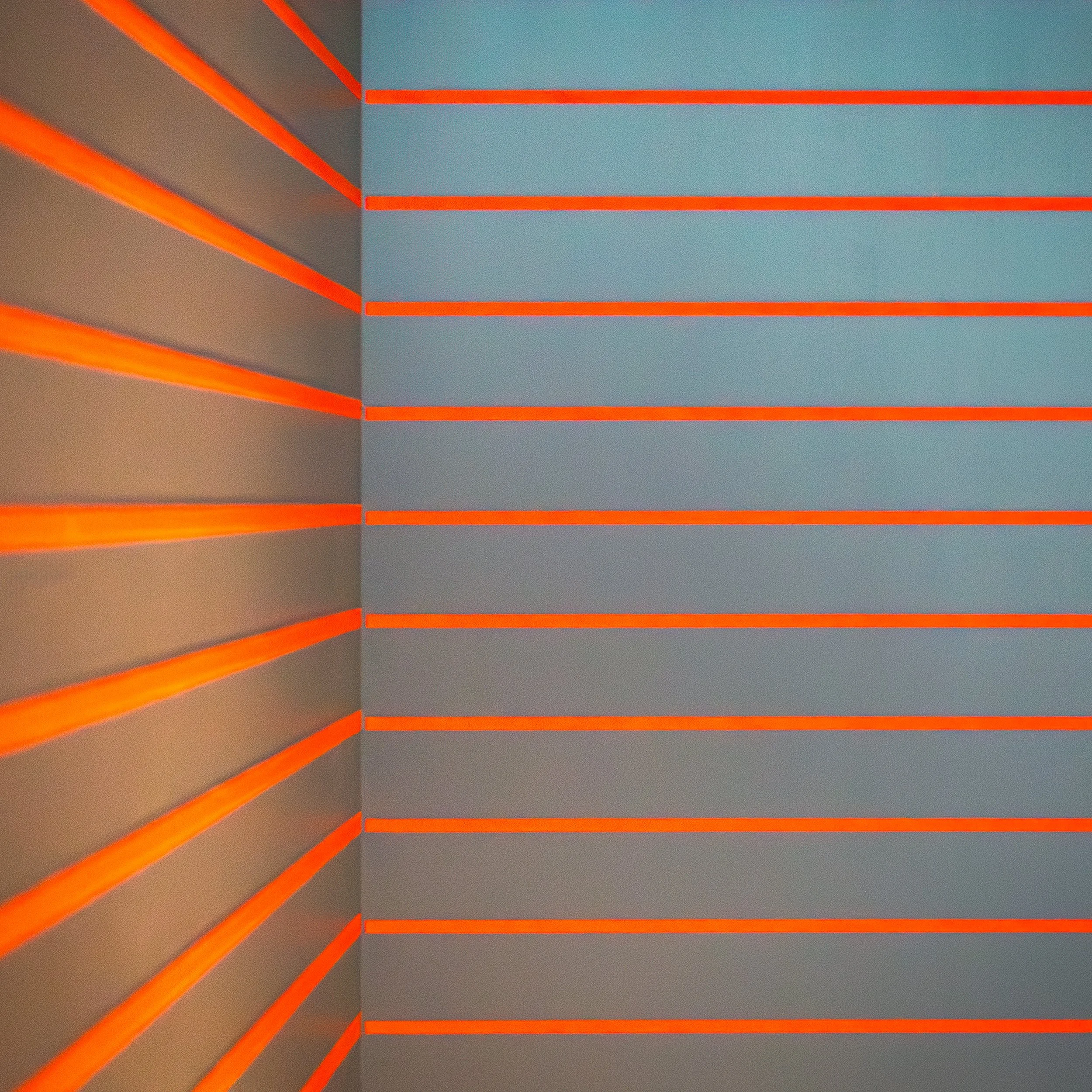 Orange horizontal lines wrapping around a grey architectural corner