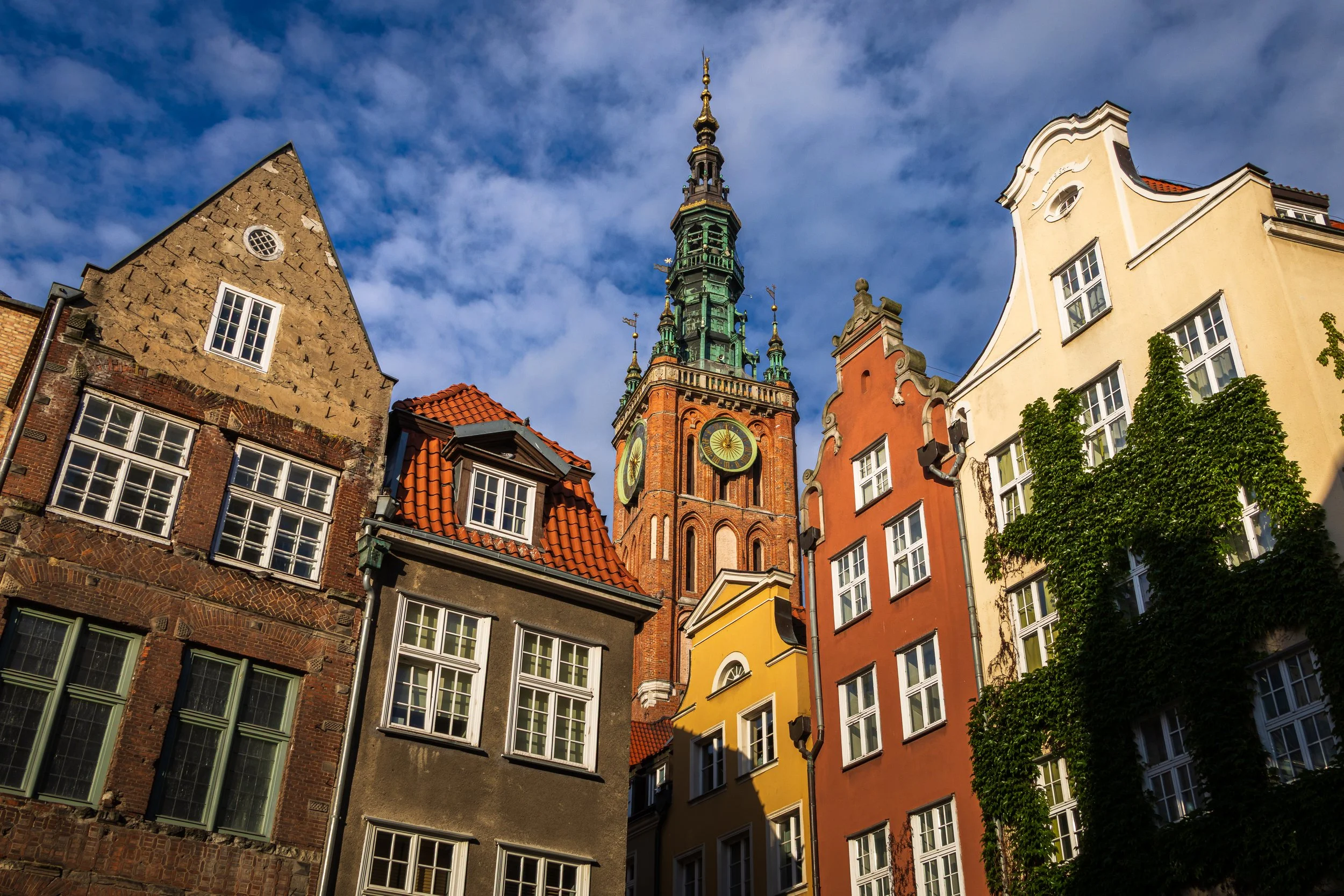 Historic architecture and the town hall tower rising above the buildings in central Gdańsk.