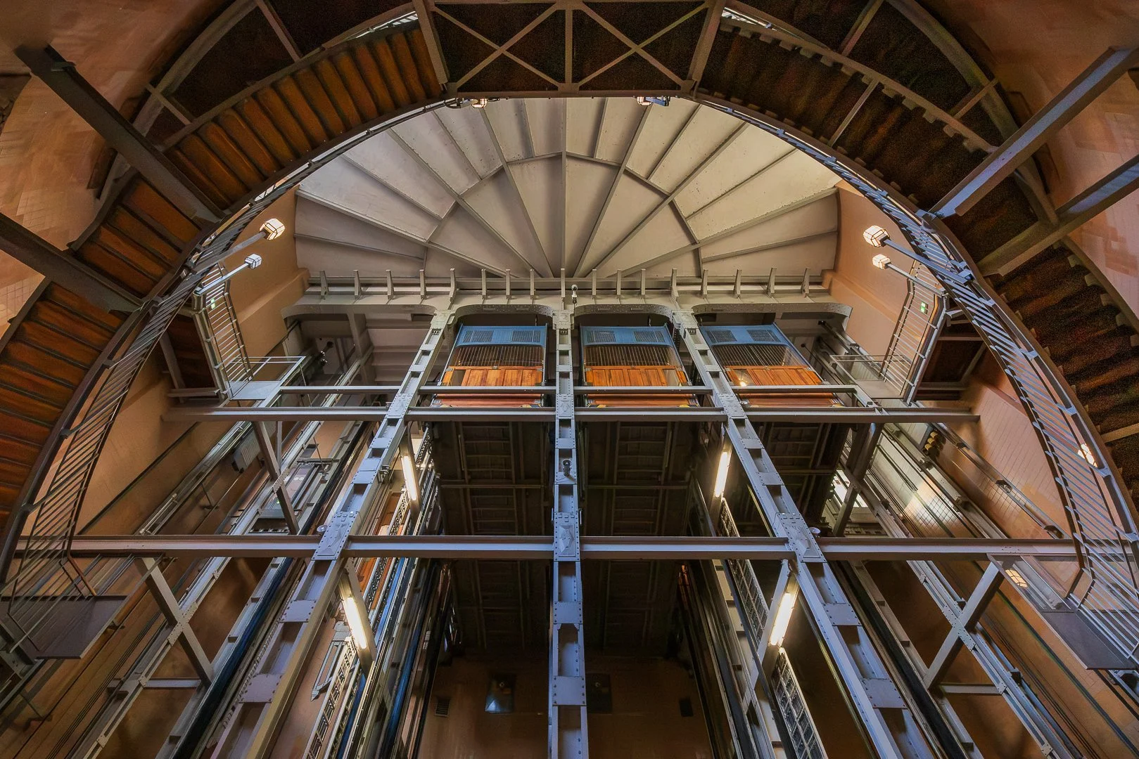 Technical architectural interior in Hamburg with repeating steel beams, stairways and curved structural elements.