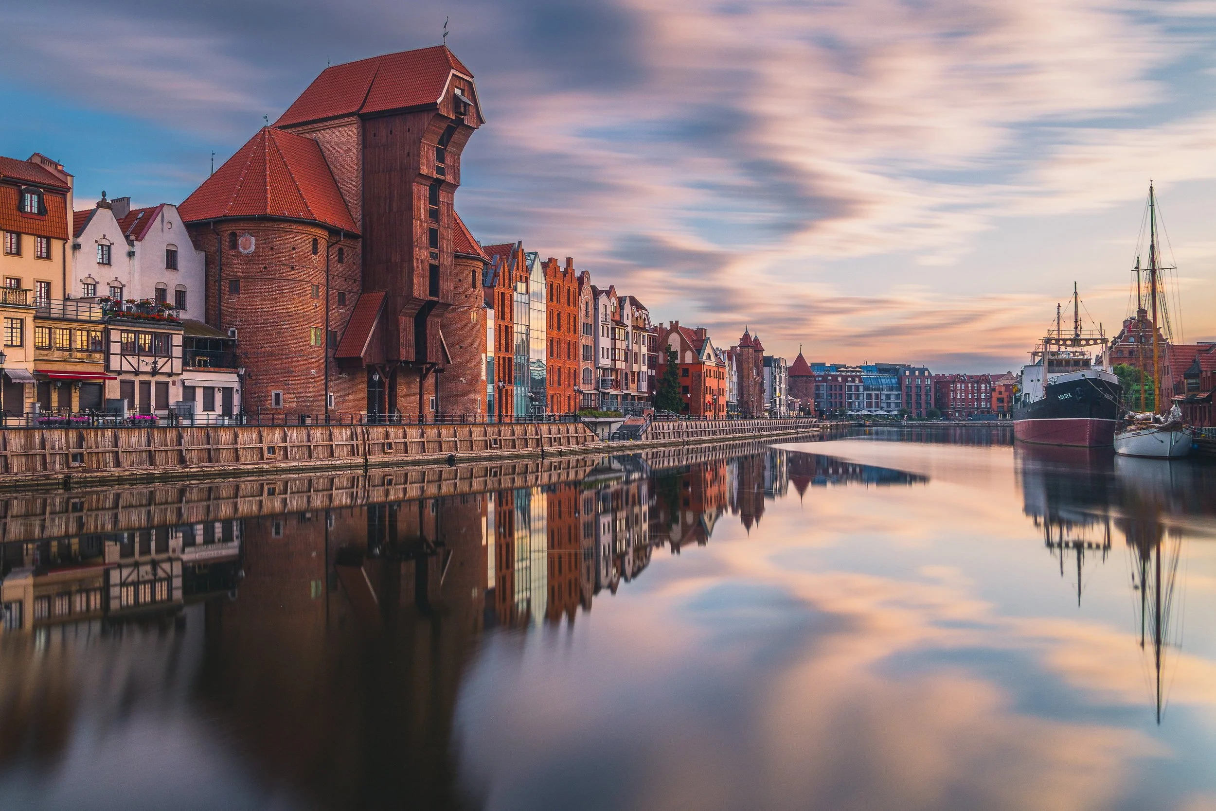 Historic Gdańsk waterfront with the medieval crane reflected in the Motława River