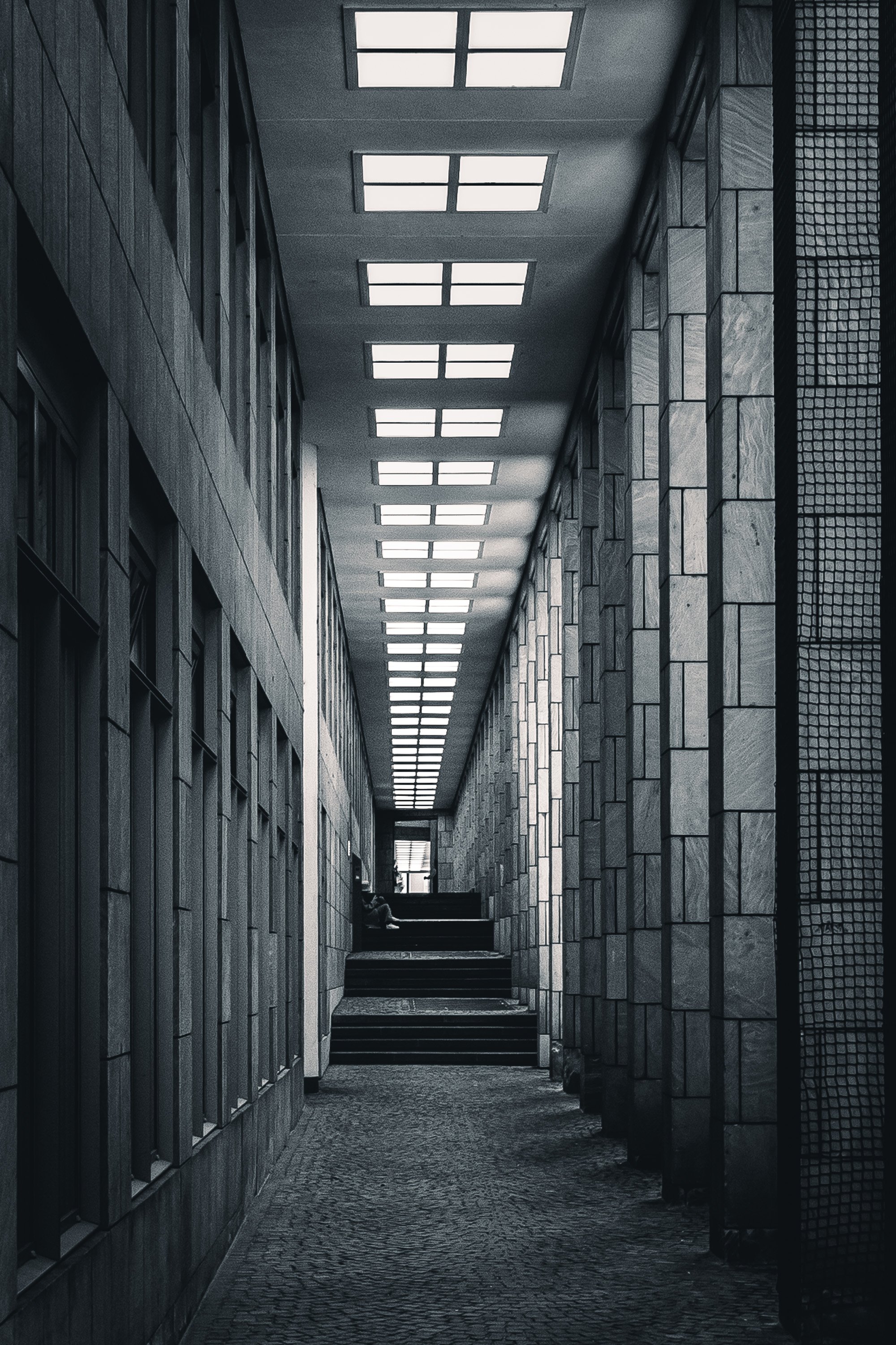 Black and white corridor at the Schirn in Frankfurt with repeating ceiling lights and strong perspective