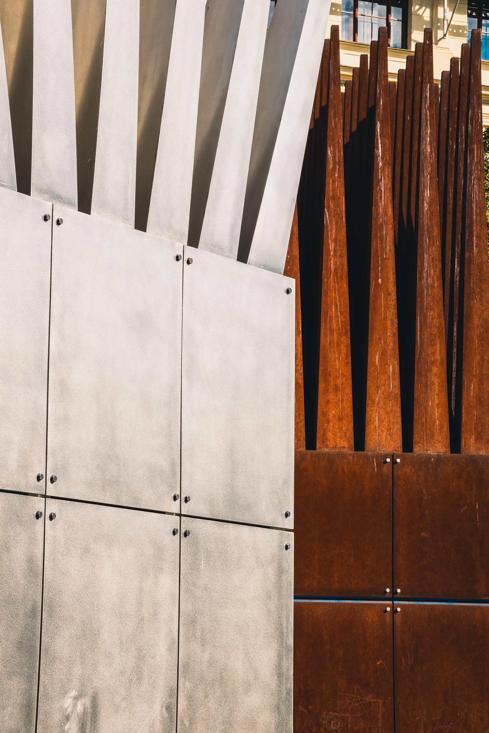 White and rust-colored metal structures forming strong geometric lines in Prague