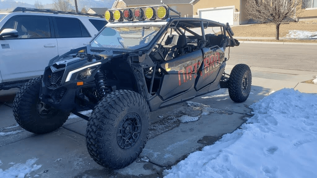 Customized side by side with custom metal light bar, roll cage, and grill