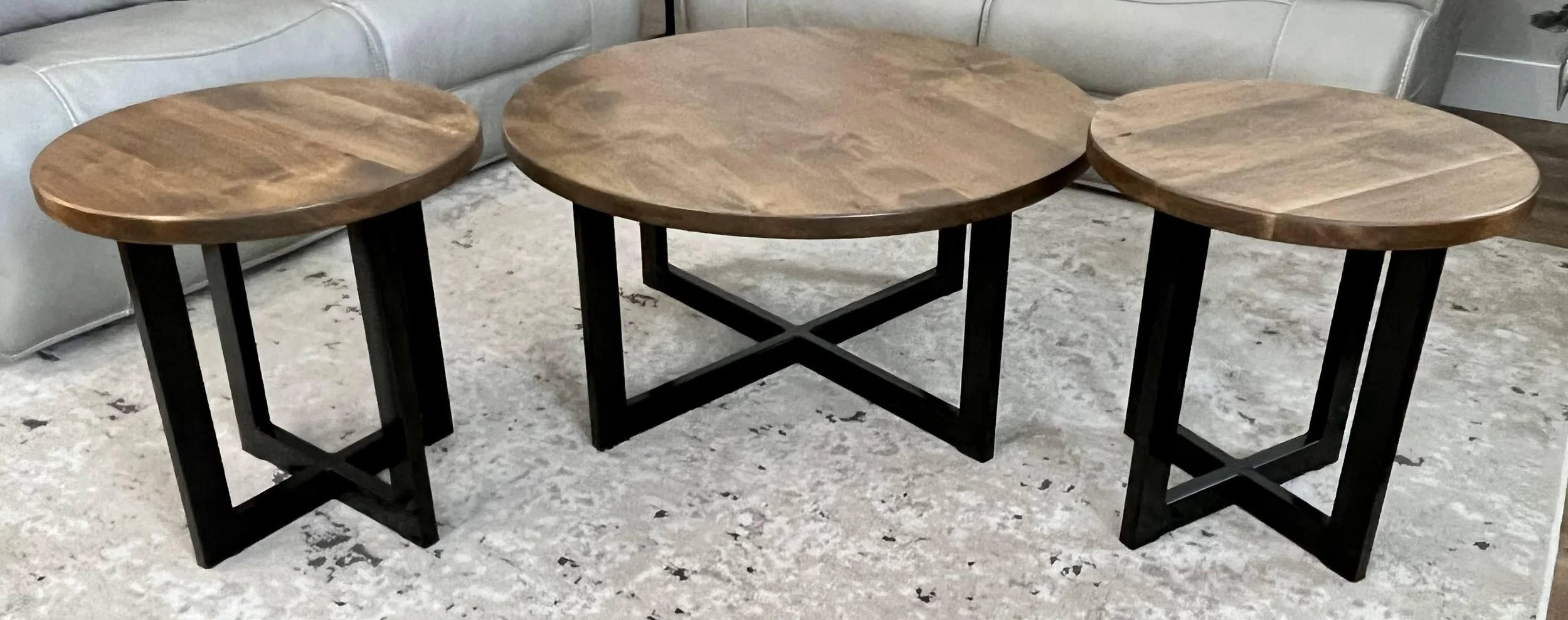 Custom coffee and end tables with crossed metal beams.