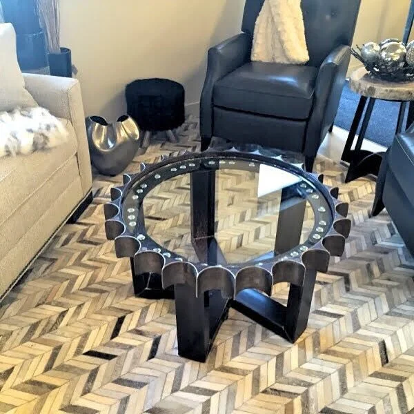 Custom gear table with crossbeams at the base and a glass top