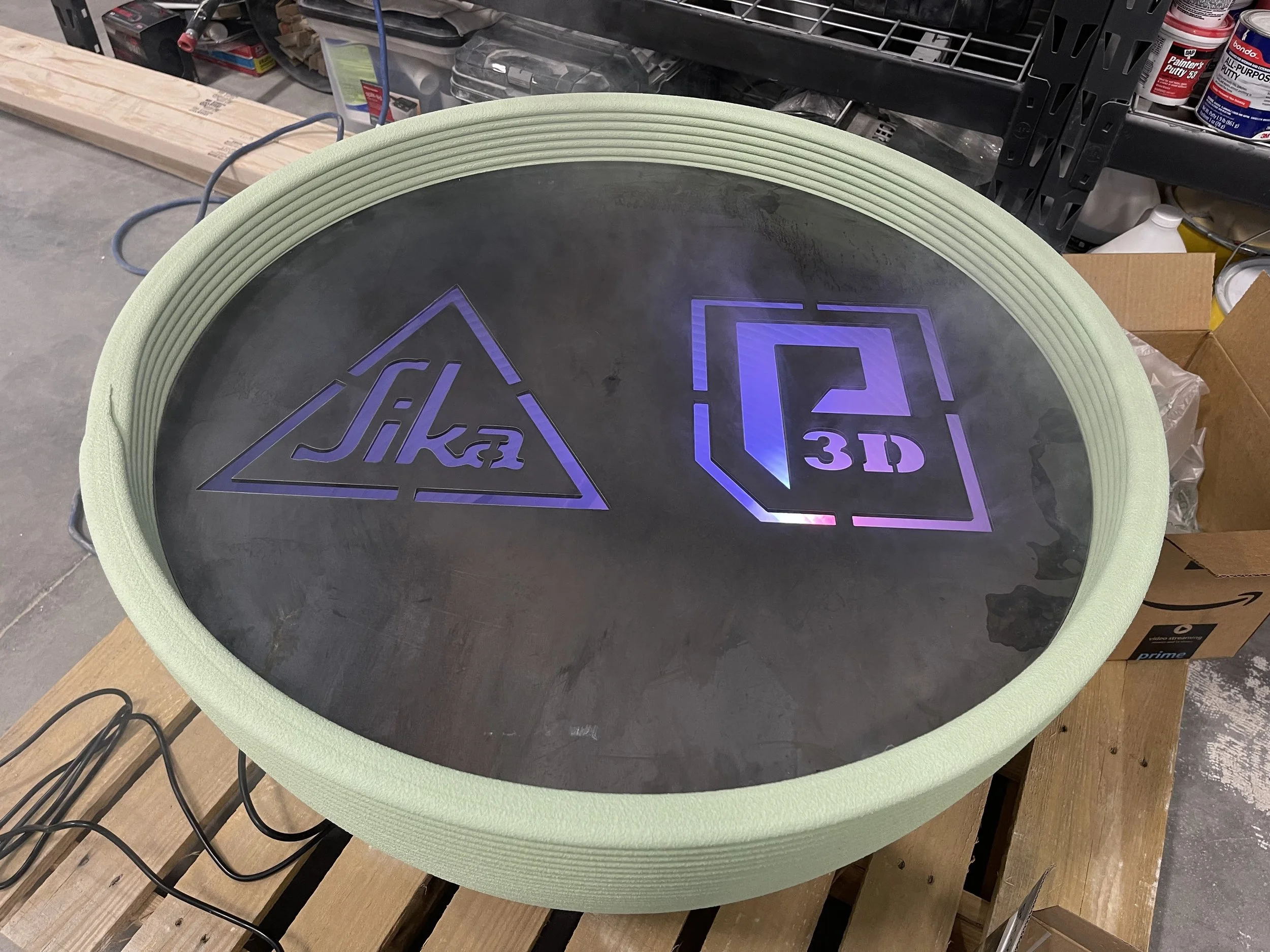 Plasma cutouts of company logos to fit a custom desk