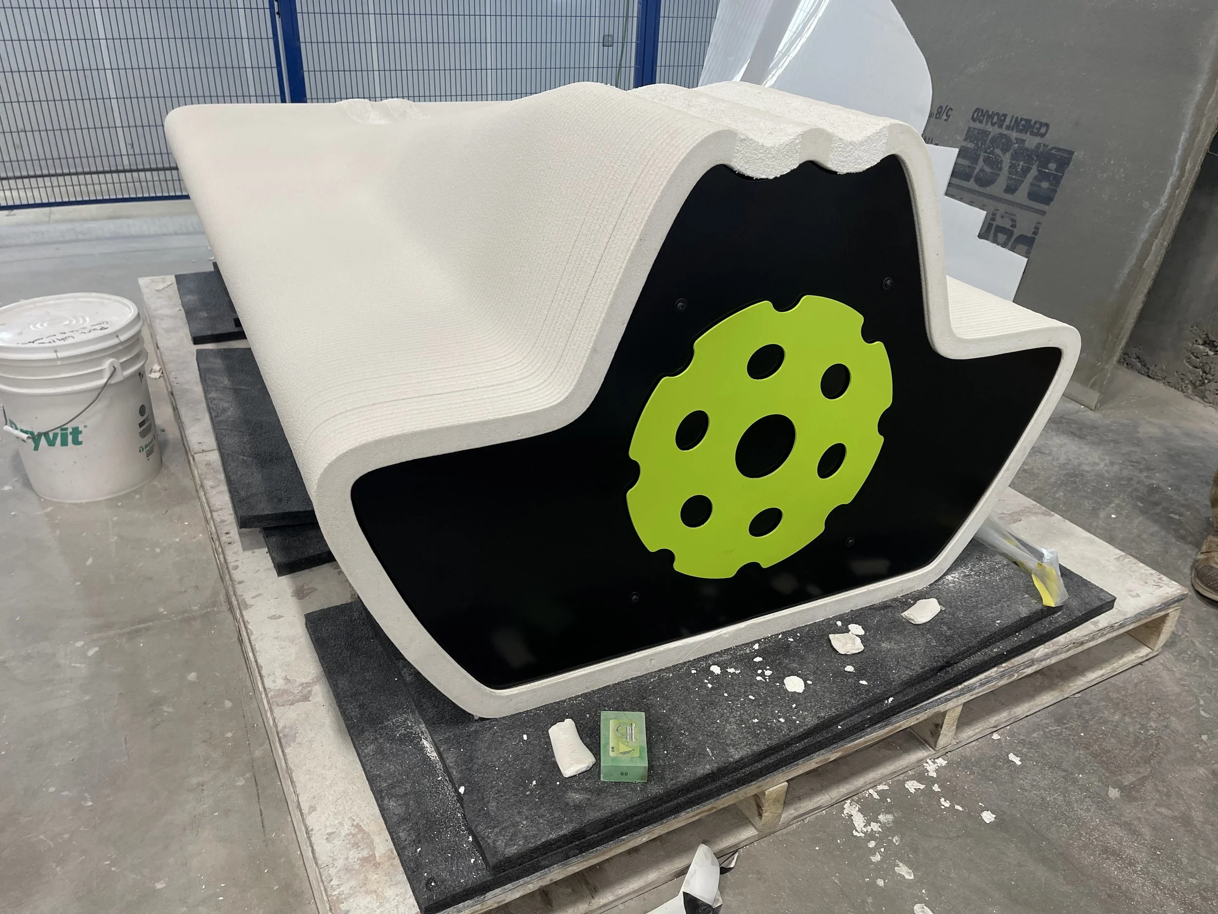 Pickleball sign in powder coated neon green stuck on a custom bench endcap. 