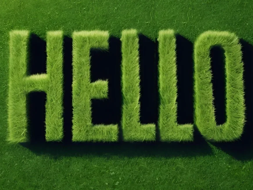 Large decorative sign spelling 'HELLO' made of green grass-covered letters on a grass background.