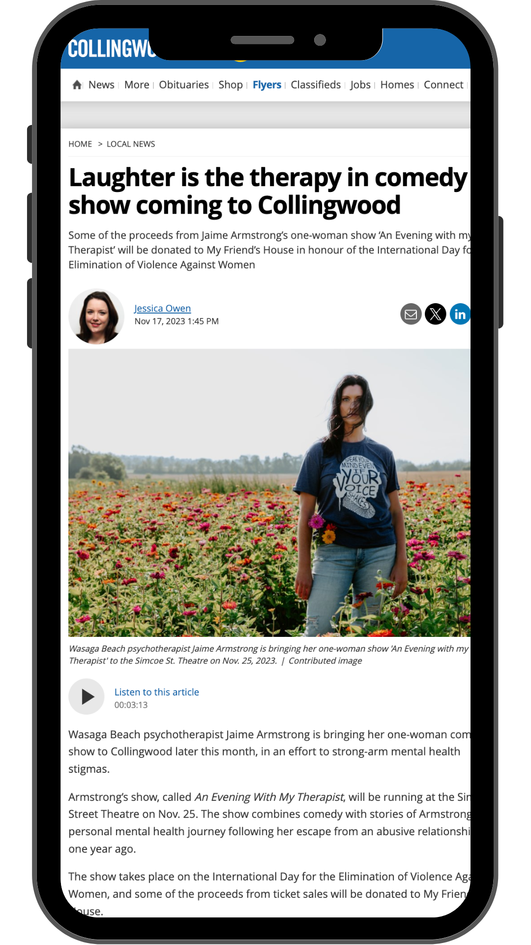 A smartphone displaying a news article about comedian Jaime Armstrong's one-woman show 'An Evening with My Therapist' at the Simcoe Street Theatre. The article features a photo of Jaime Armstrong standing in a field of pink and orange flowers, wearing a blue T-shirt and jeans.