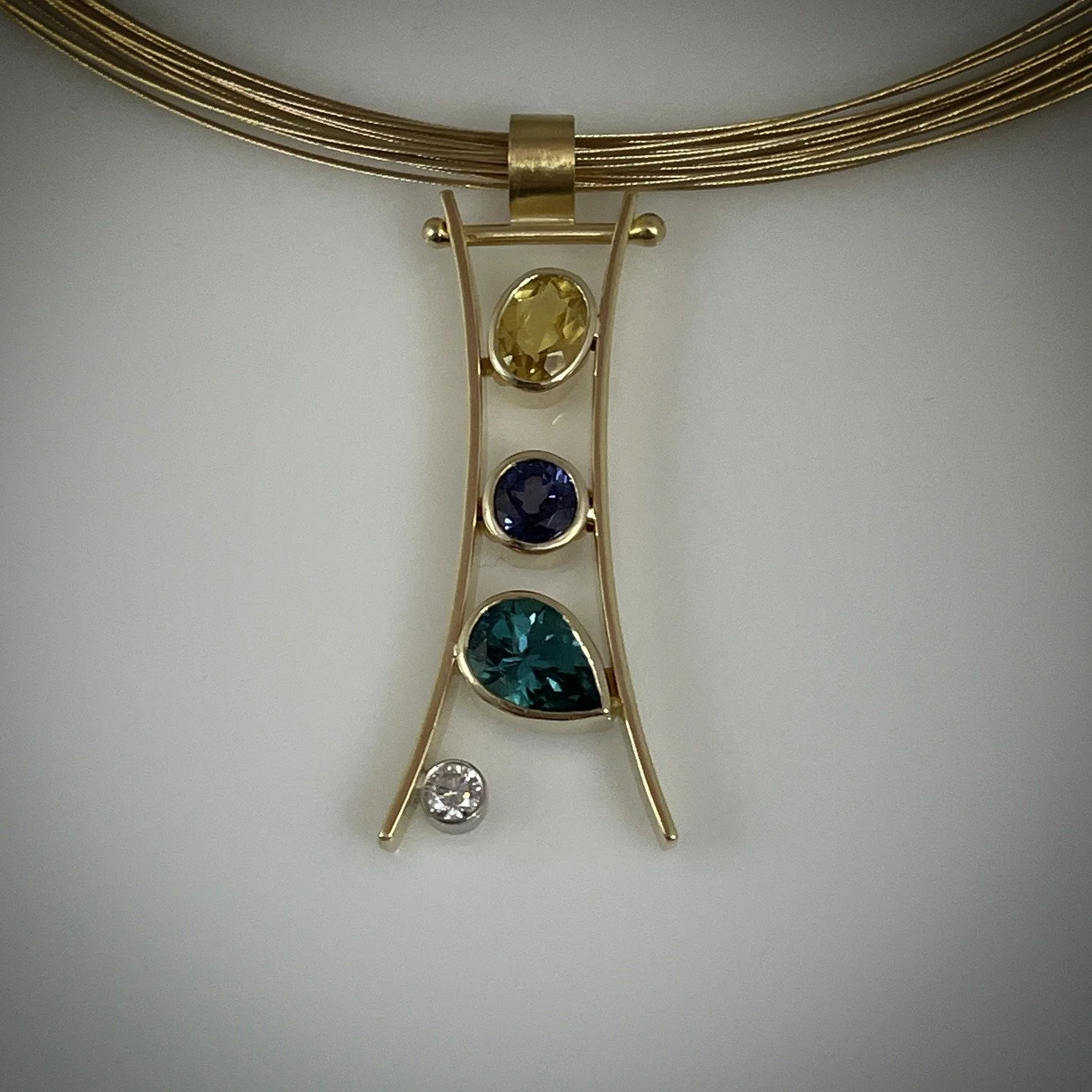 HOT OFF THE BENCH
18k yellow gold pendant with Golden Beryl, Purple Spinel, Green Tourmaline and diamond
COME SEE WHAT'S NEW