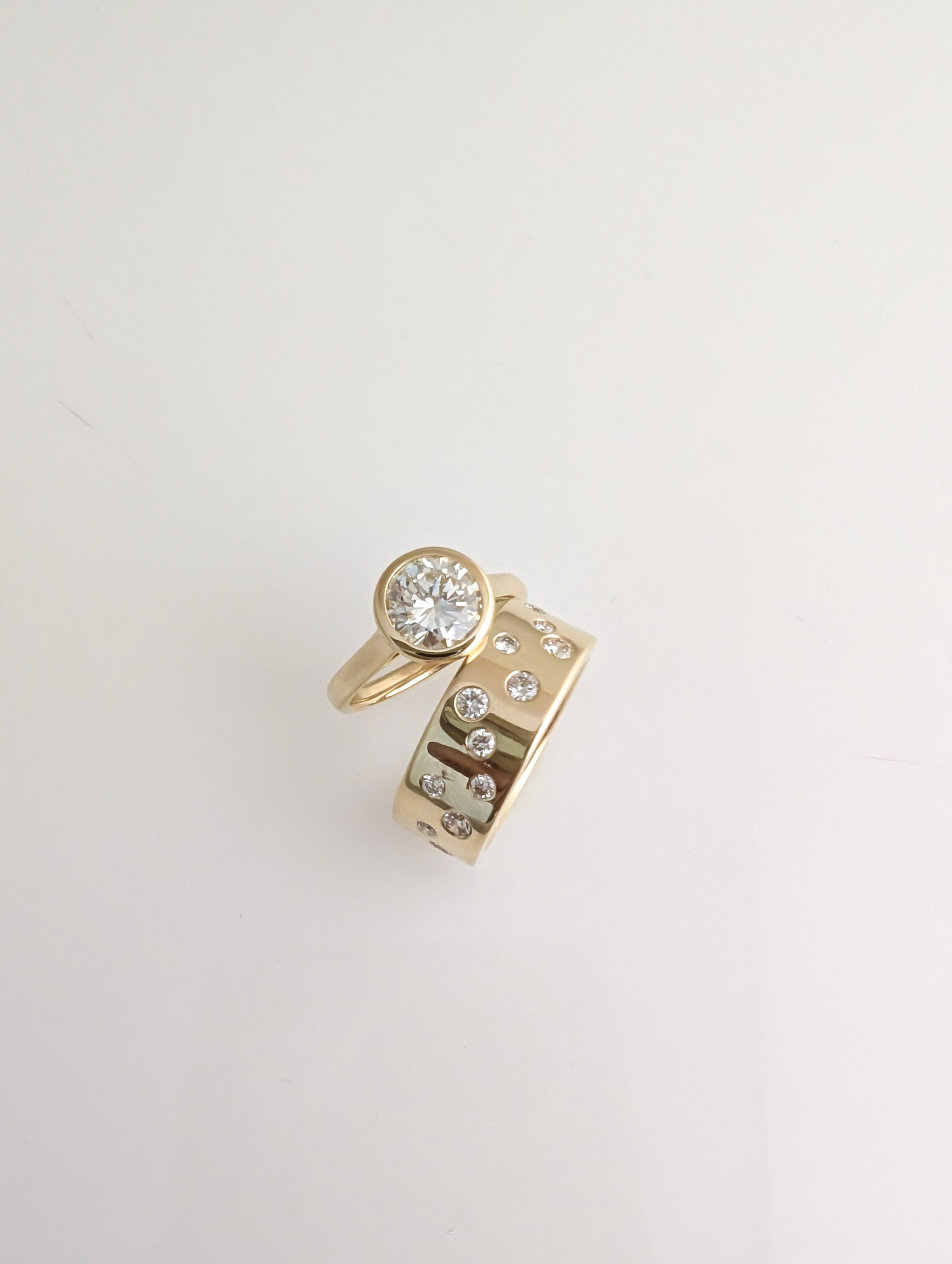 custom 18k gold diamond ring stack, made to shine. 1.50ct solitaire diamond and 0.71cttw diamond scattered band.