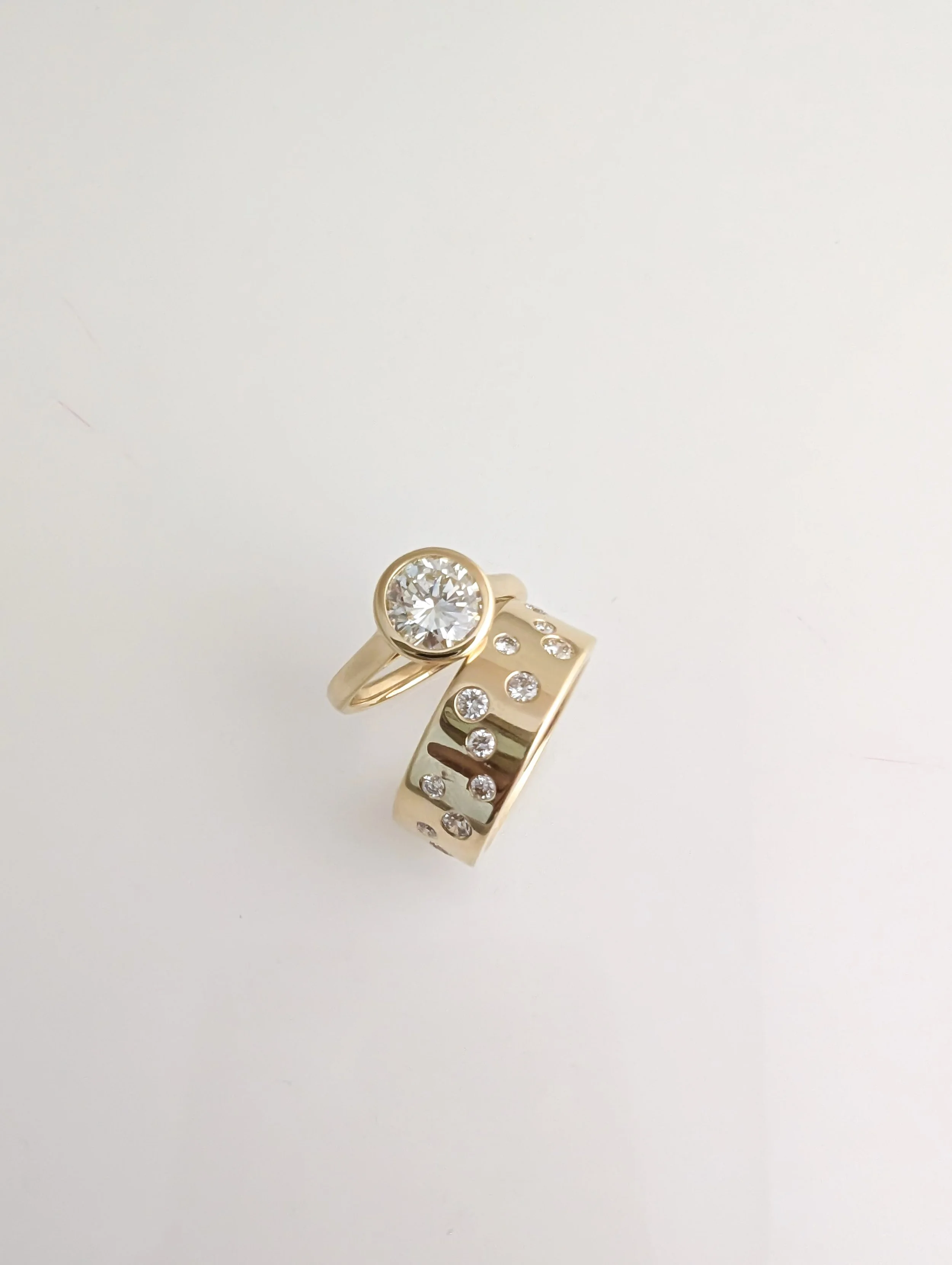 custom 18k gold diamond ring stack, made to shine. 1.50ct solitaire diamond and 0.71cttw diamond scattered band.
