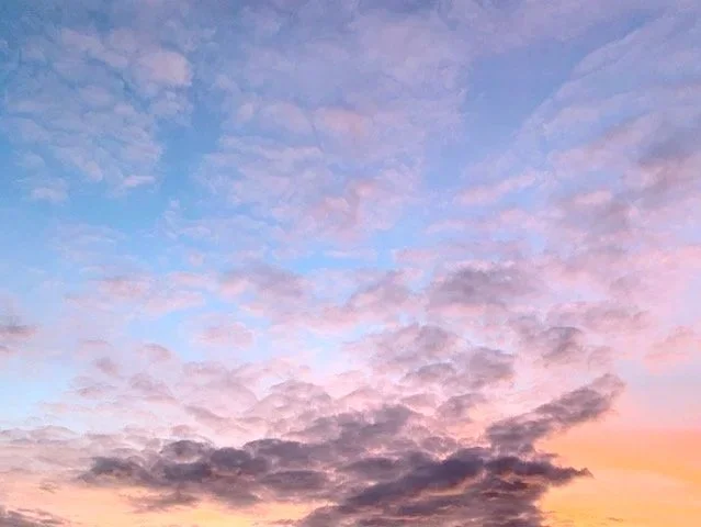 A sunset sky with pink, purple, and blue clouds.