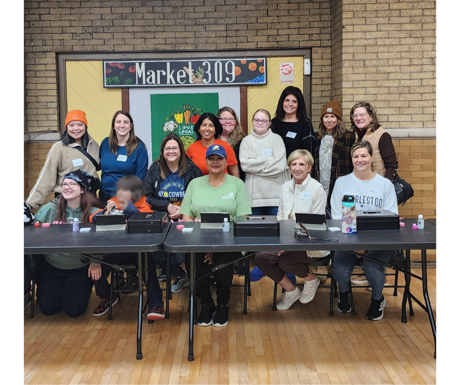 Women in leadership helping at market event