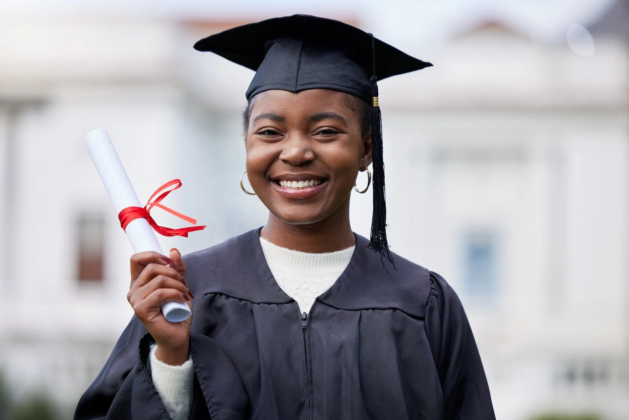 Picture of a women holding her diploma at graduation