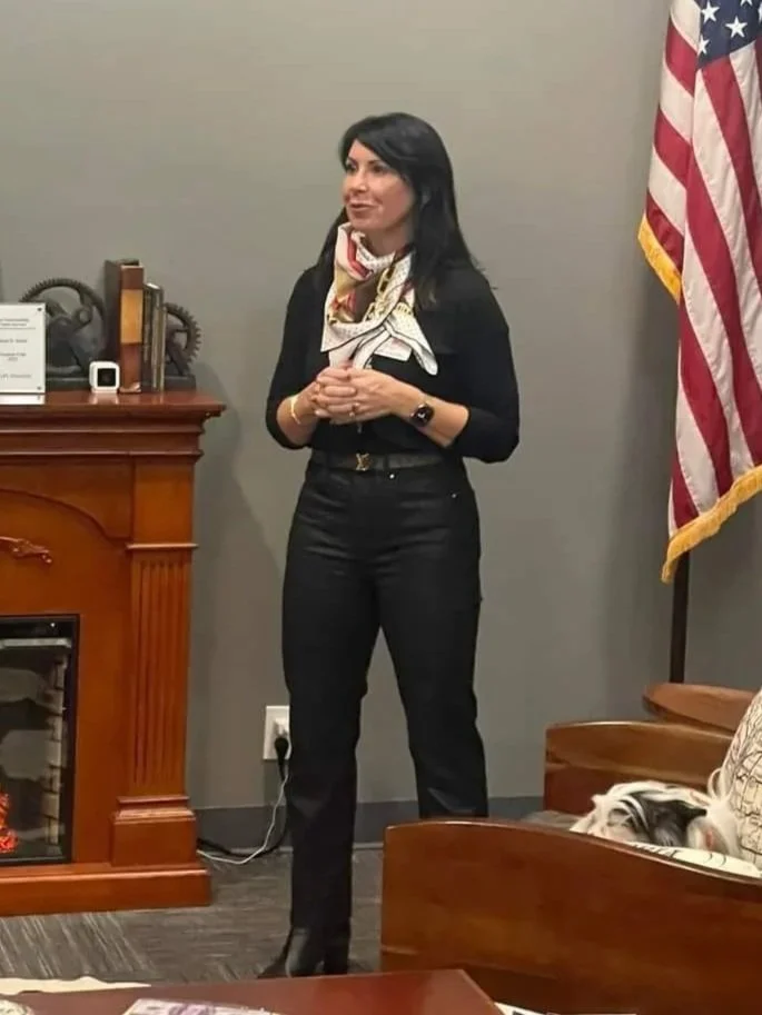 Women in leadership member speaking at an event.