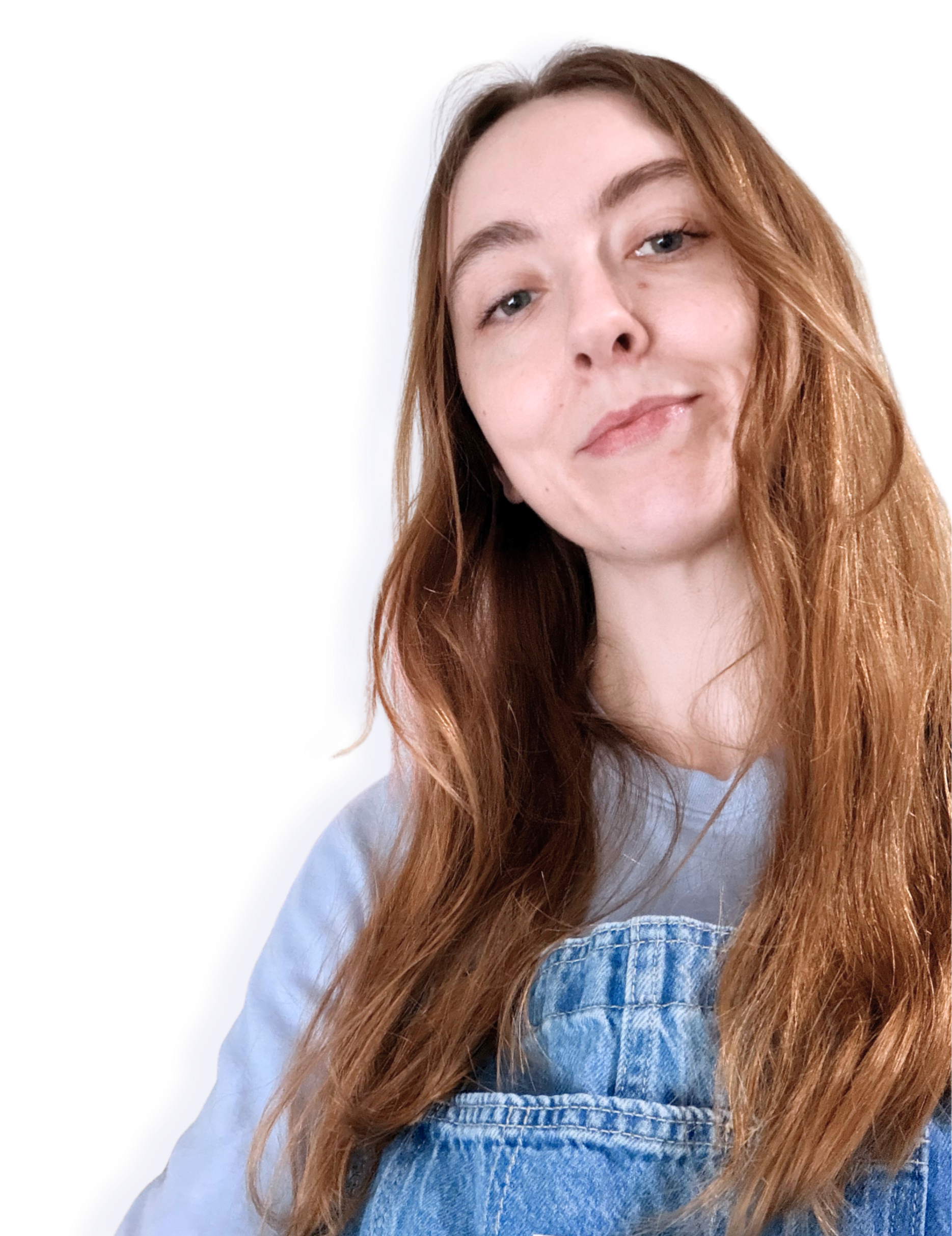 Close-up of a young woman with long brown-blonde hair, wearing a denim top over a light-colored shirt, looking at the camera with a slight smile.
