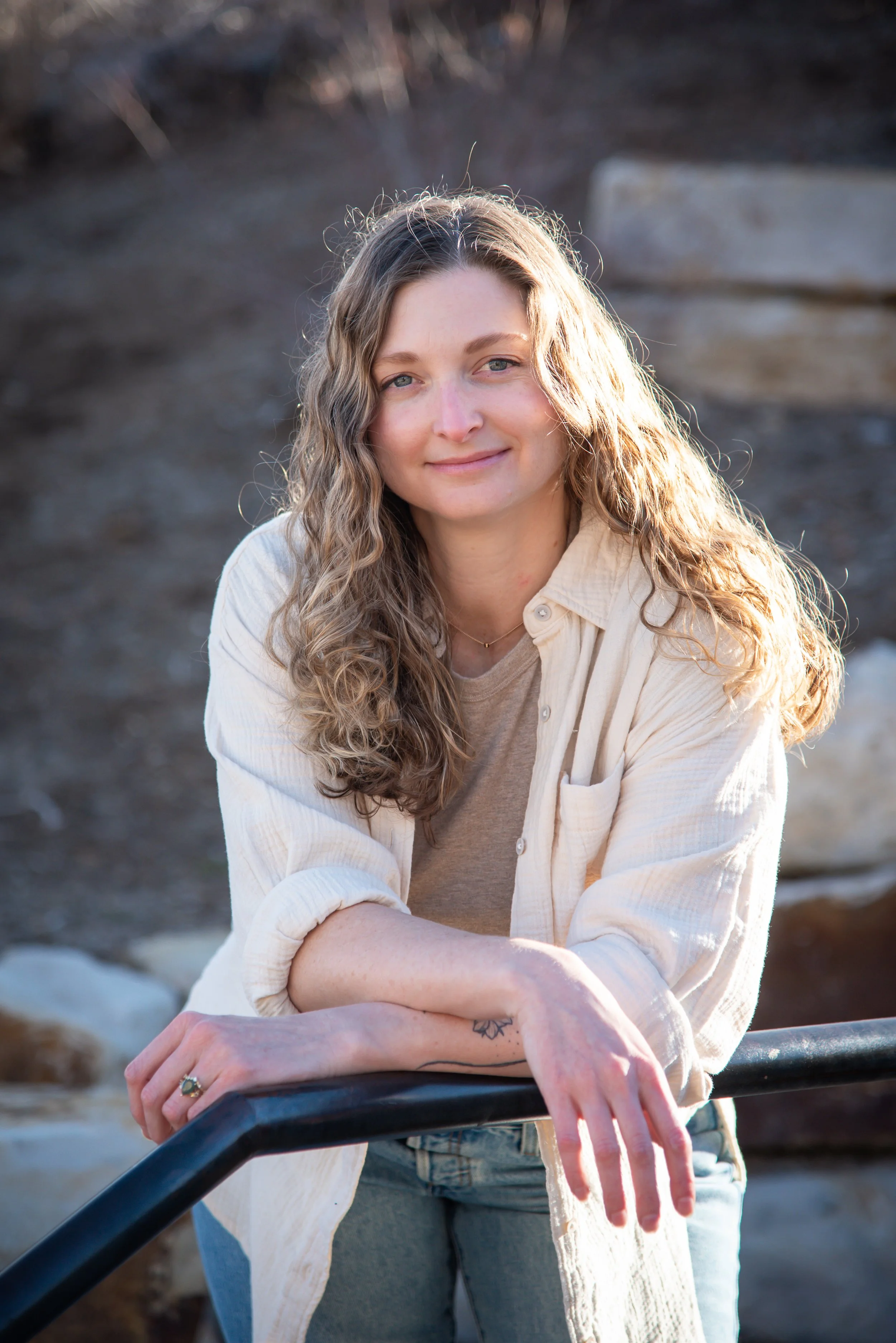 Laura Vogel, licensed therapist in Colorado specializing in anxiety, leaning on railing outdoors